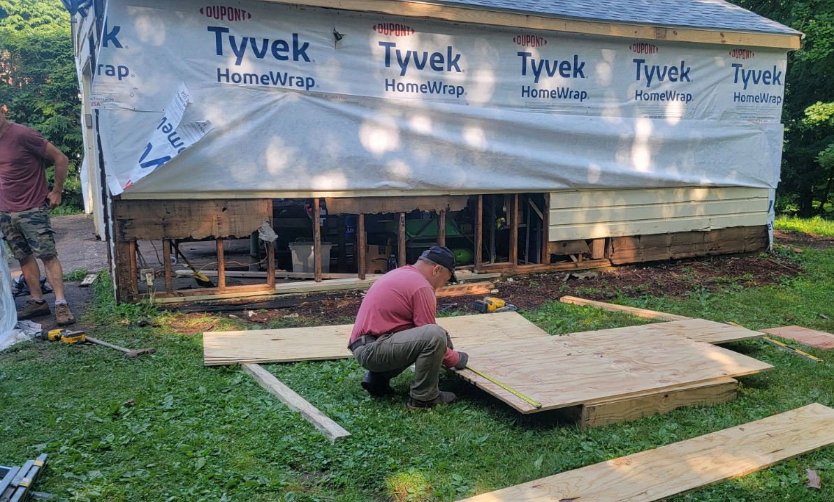 tyvek home wrap on a garage before insulated vinyl siding replacement